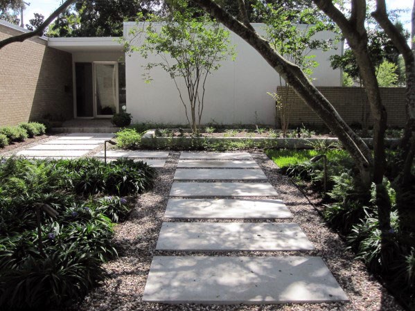 A garden pathway adorned with trees and shrubs.