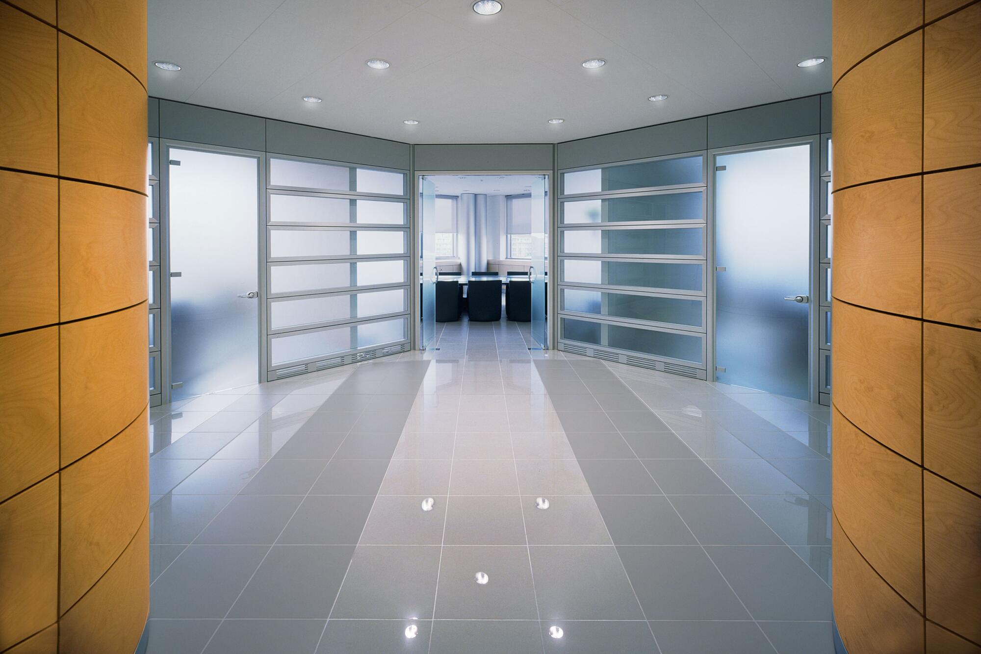 A home hallway with glass doors and white walls.