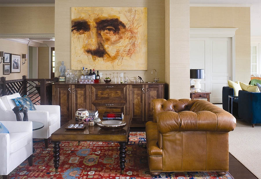 A masculine living room with a painting on the wall.