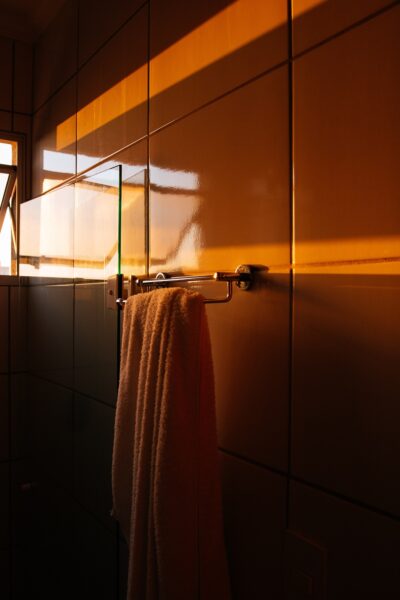 A small towel hanging on a hook in a bathroom, adding to the decor.