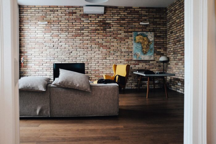 A living room decorated with a brick wall wallpaper.