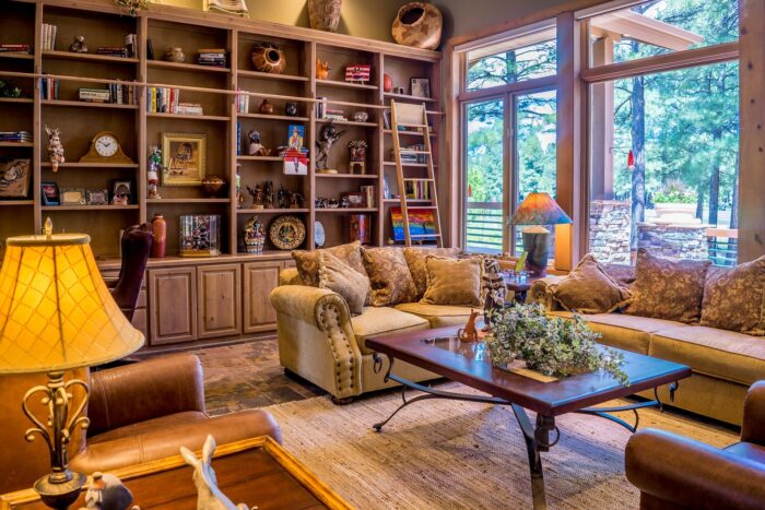 A living room with lots of furniture and bookshelves.