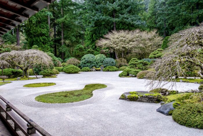 A Zen-inspired Japanese garden with serene trees and intricate rock formations.