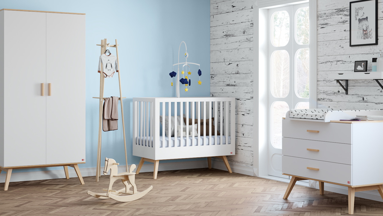 A baby's room with a crib and dresser, designed for nesting.