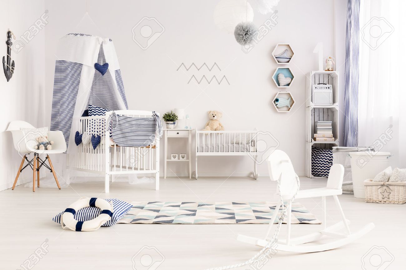 A baby room with a rocking chair for nesting tips.