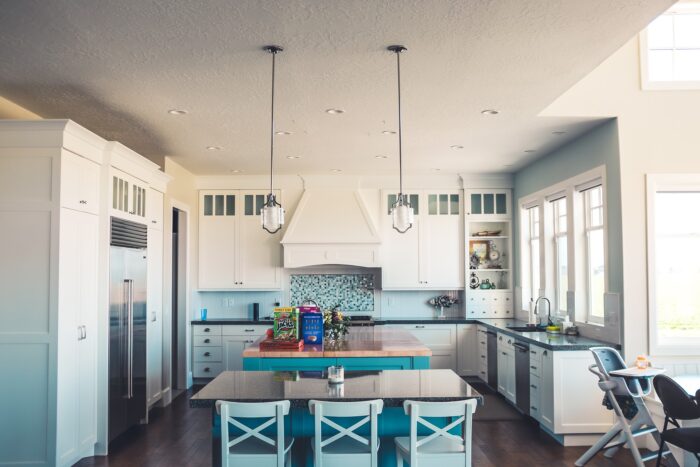 A kitchen with a blue counter top and white cabinets.