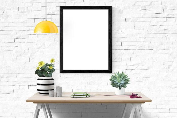 A black-framed white table showcasing a potted plant.