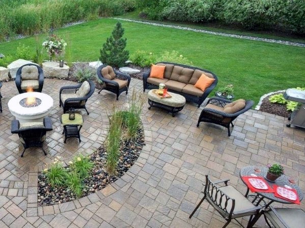 A patio with furniture and a fire pit in the backyard.
