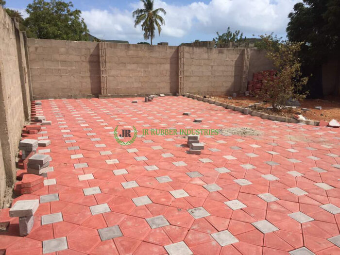A backyard with a red tiled floor showcasing architectural design.