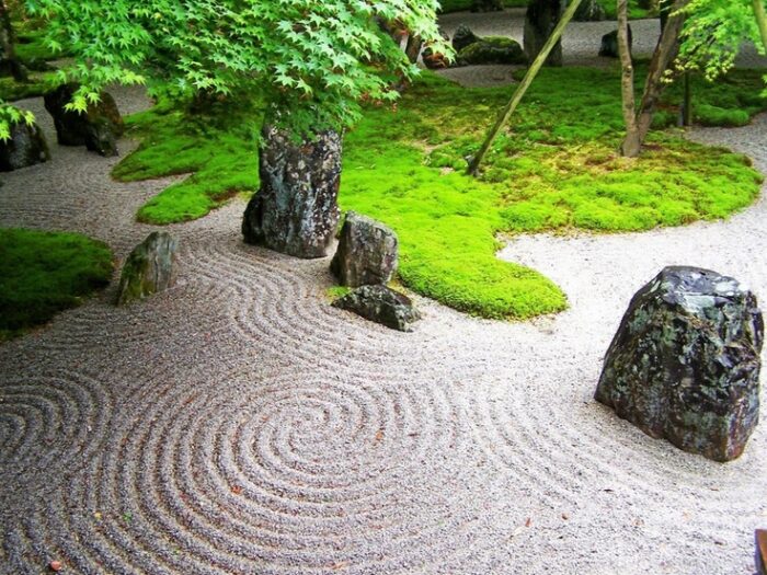 A Zen garden with rocks and moss.