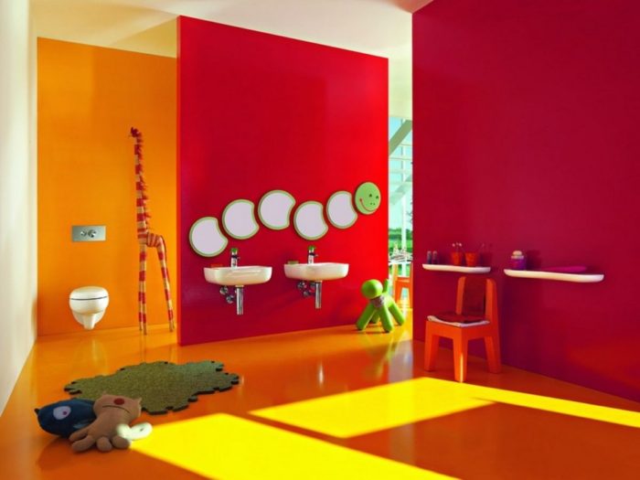 A brightly colored bathroom with a toilet and sink for kids bathroom ideas.