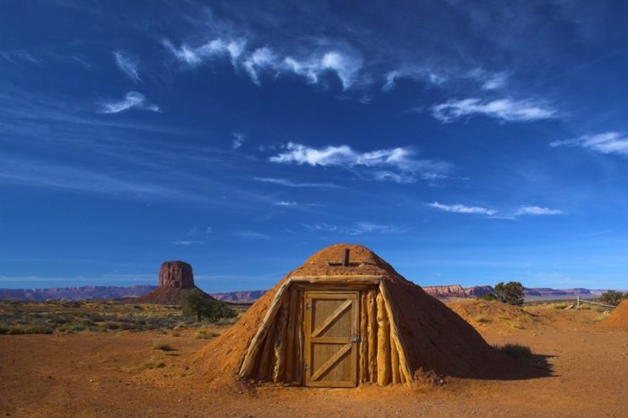 An underground adobe hut in the desert.