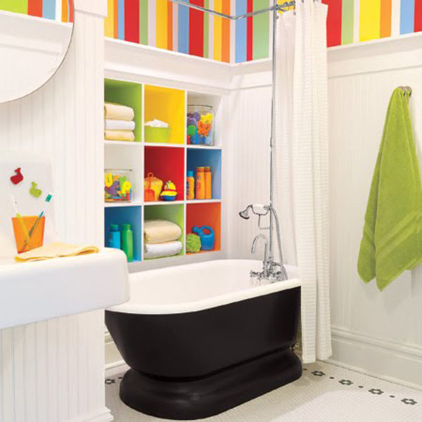 A kids bathroom with striped walls and a bathtub.