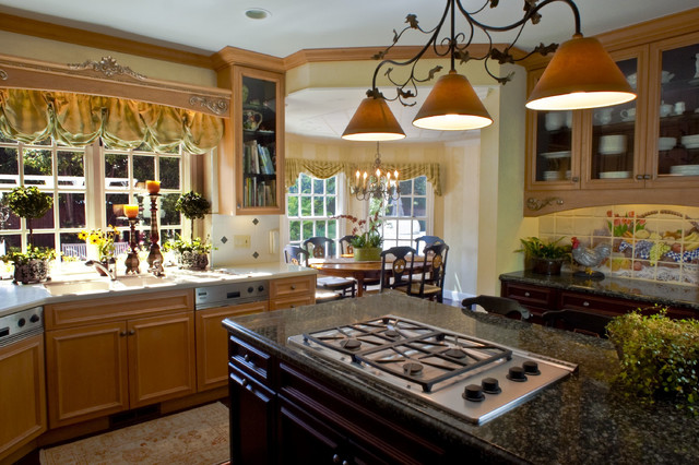 A kitchen with granite counter tops and wooden cabinets featuring innovative window ideas.