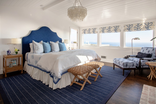 A beach style bedroom with an ocean view.