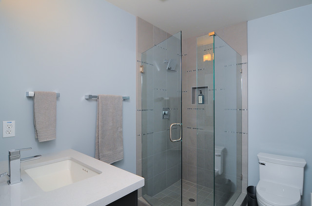 A glass shower stall in a bathroom.