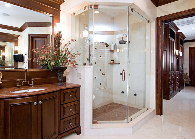 A spacious bathroom featuring a sleek glass shower stall.