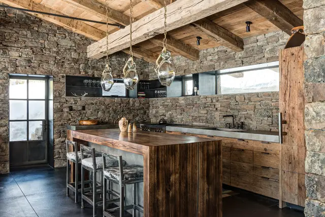 A Rustic Kitchen with Stone Walls and Wooden Beams.