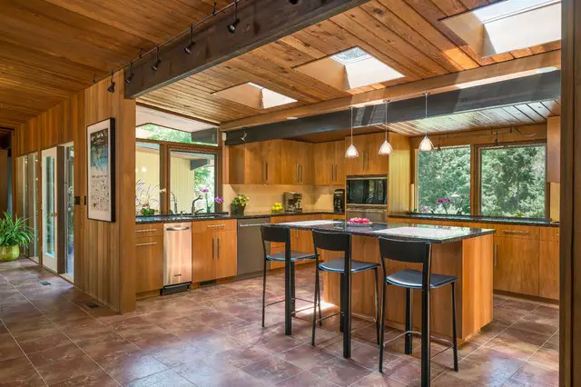Rustic kitchen with wooden ceilings and floors.
