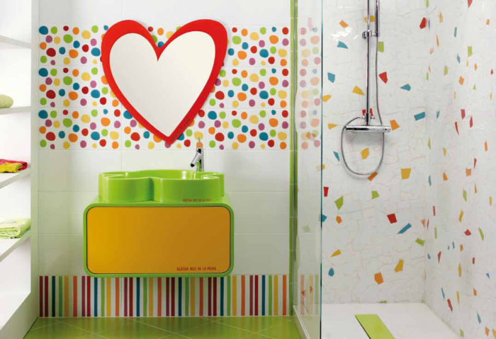 A fun kids bathroom with colorful polka dots on the walls.