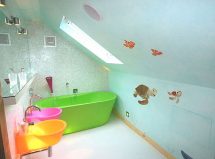 A brightly colored kids bathroom with a bathtub and sink.