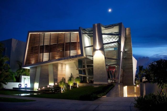A contemporary house lit up at night.