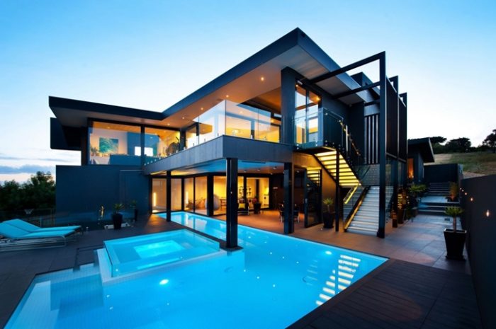 A contemporary house with a pool and stairs.