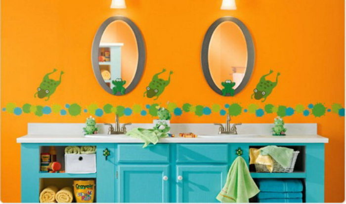 A kids bathroom with two sinks and two mirrors.