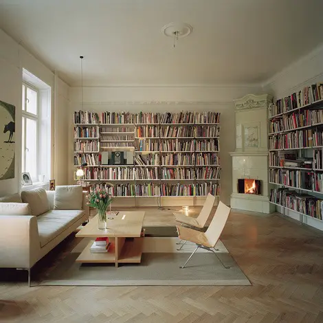 A cozy living room with bookshelves and a fireplace, making it a perfect home library.