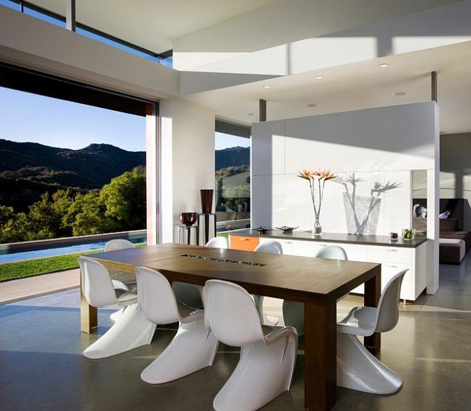 A minimalist dining room with a view of the mountains.