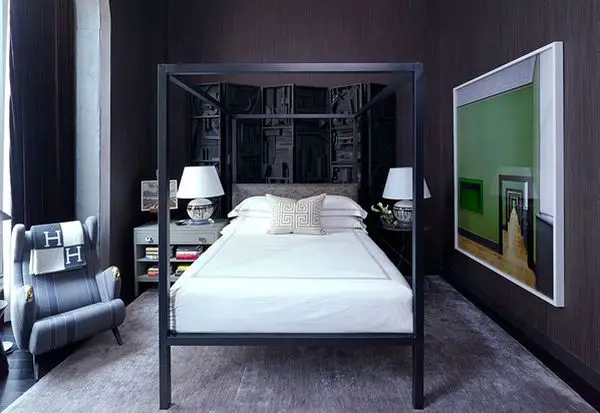 A bachelor pad bedroom with a black and white four poster bed.