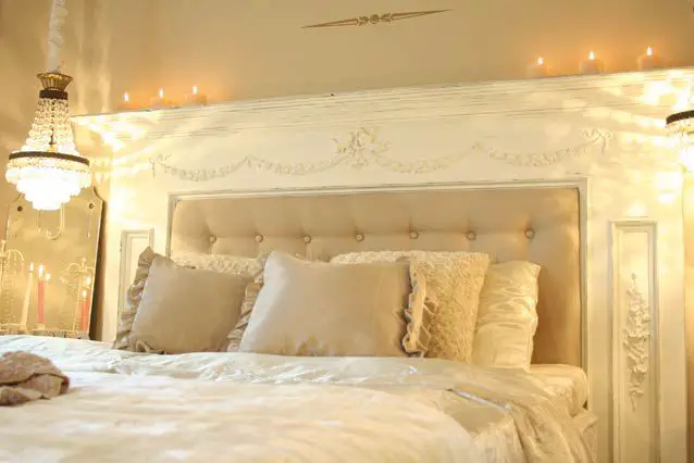 A bed with a white headboard.