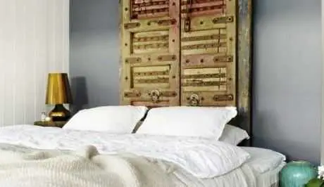 A creative headboard made from an old door for unique bed ideas.