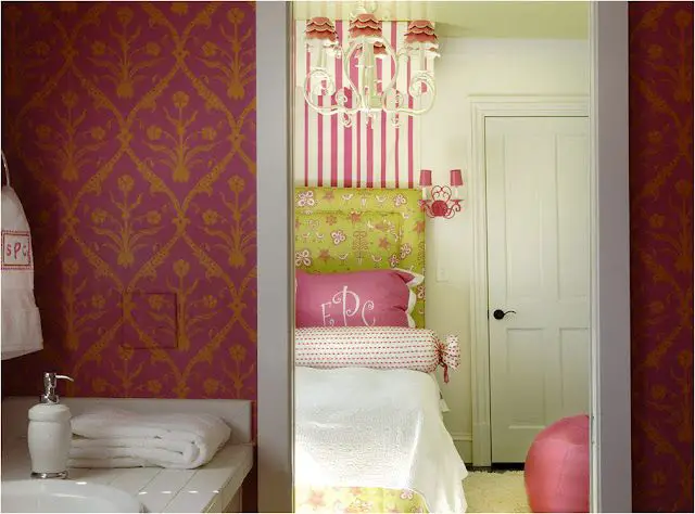 A pink and yellow bedroom with a bed.