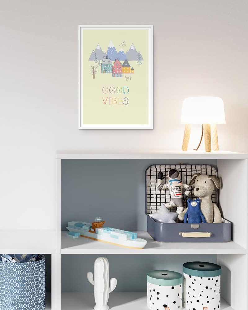 A detailed guide on arranging pictures on a child's room wall with a teddy bear and toys.