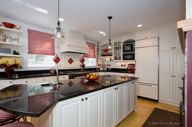 A white kitchen with black counter tops and red accents featuring kitchen window ideas.