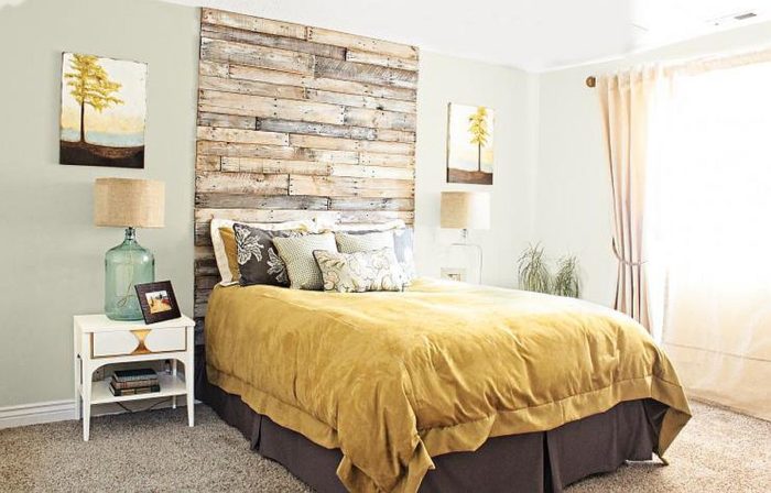 A DIY bedroom with a wooden headboard.