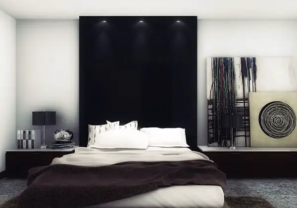 A black and white bachelor pad bedroom with a black headboard.