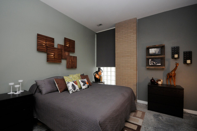 A bedroom with a bed and a bedside table featuring bedroom wall decoration.