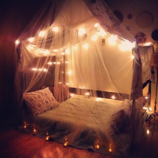 A bedroom adorned with fairy lights.