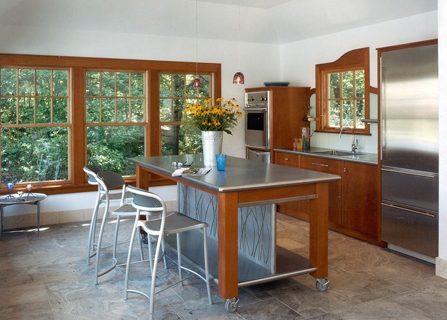 A stainless steel island is the centerpiece of this kitchen.