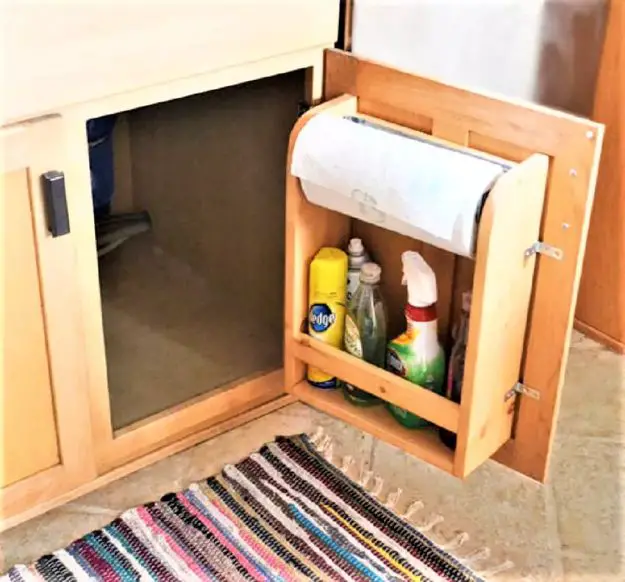 A creative kitchen cabinet makeover idea featuring a toilet paper holder.