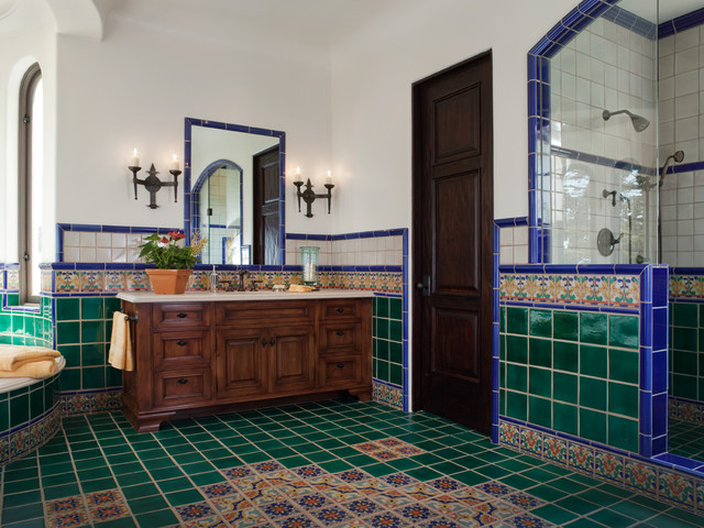 A bathroom with blue tiled walls.