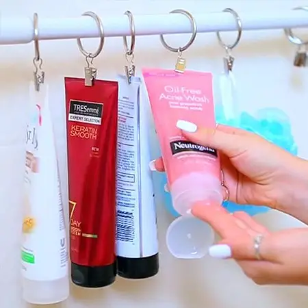 A person creatively organizes cosmetics for efficient bathroom storage space.
