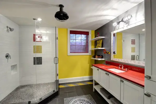 A basement bathroom with yellow walls.