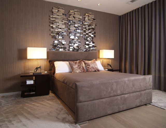 A bedroom with a large bed and a mirror on the wall, serving as a stylish wall decoration.