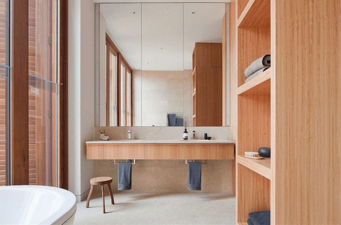 A bathroom with a bathtub and wooden cabinets.