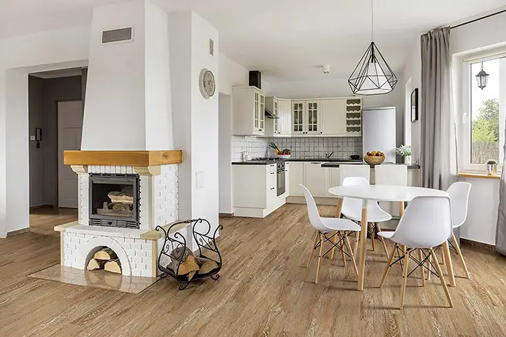 A white kitchen with wood floors.