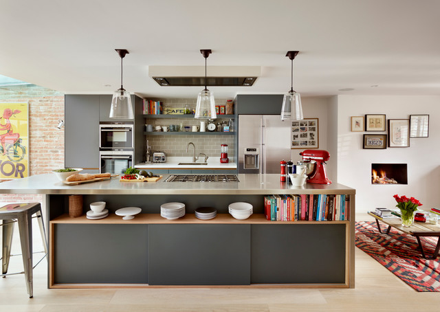 A contemporary kitchen featuring a spacious island with incorporated bookshelves.