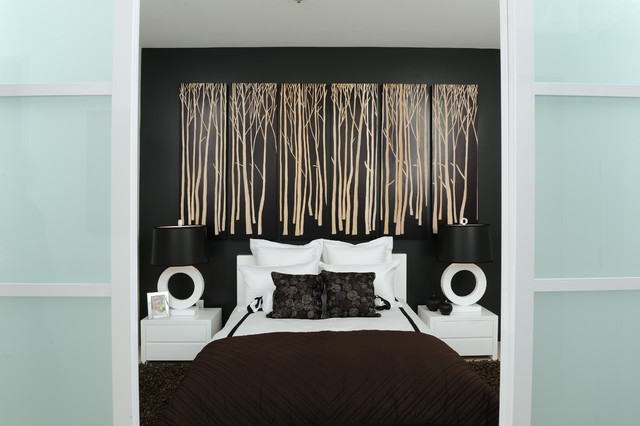 A black and white bedroom with wall decoration.